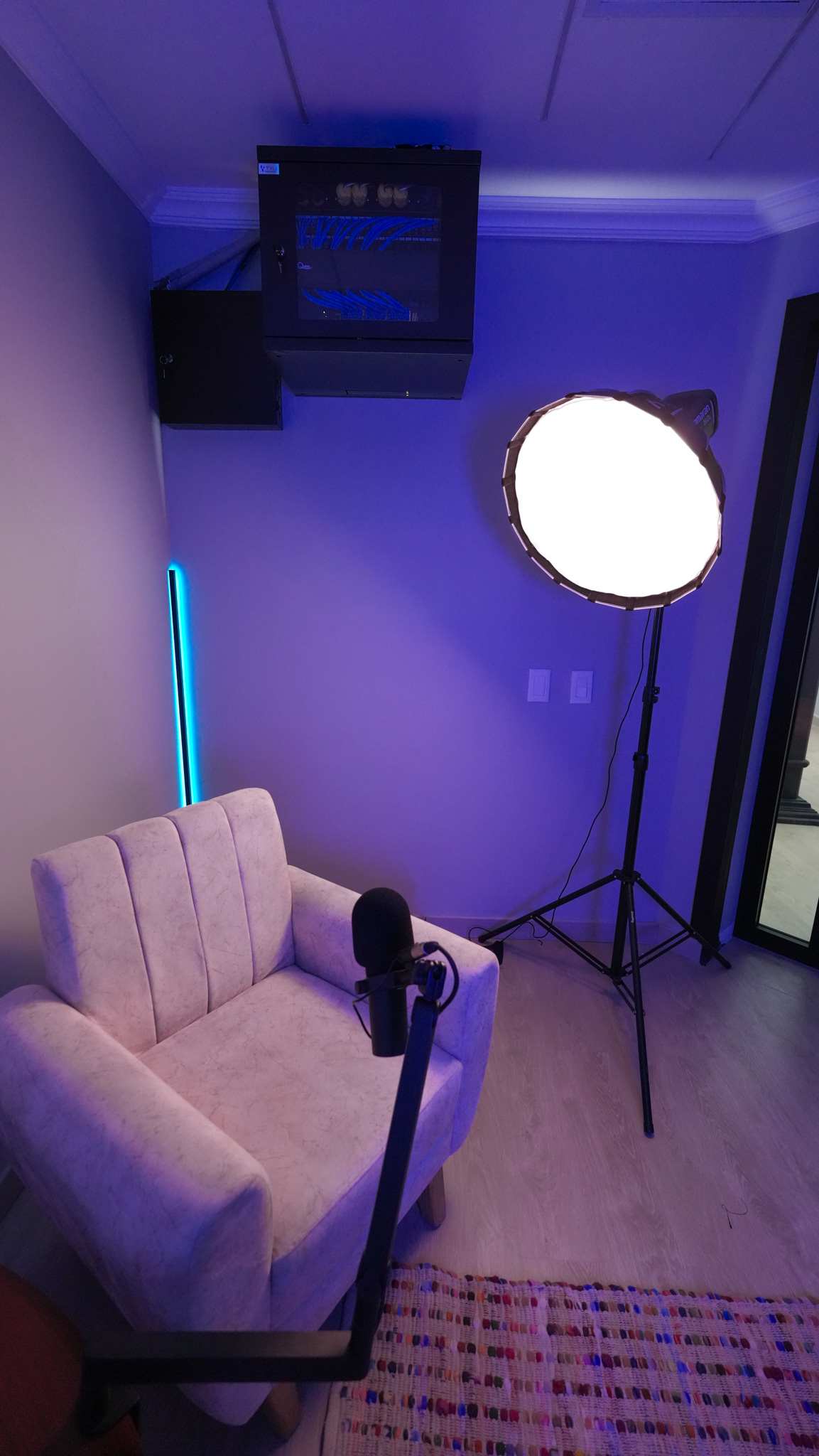 Studio corner with softbox light and ceiling-mounted tech